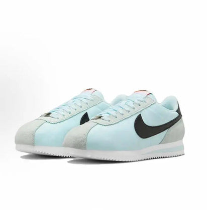 Light blue low-top sneakers with black Swoosh and white sidewall