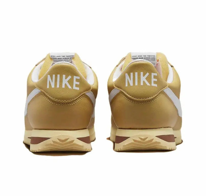 Cortez sneakers heel view with NIKE branding, wheat gold leather and brown midsole