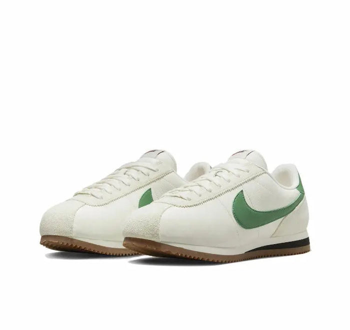 Low-top sneakers side view, white upper with green swoosh and brown gum sole