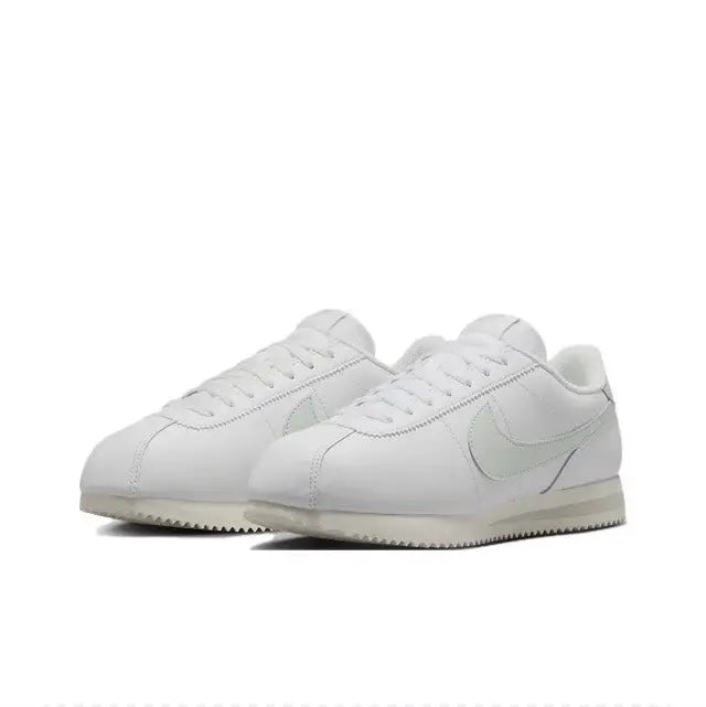 White low-top sneakers with Nike Swoosh and lace-up front