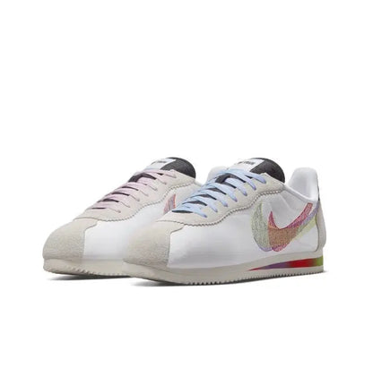 Nike Cortez sneakers, side view with white upper and multicolor Swoosh accents