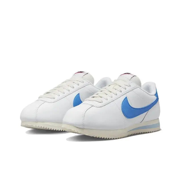 Nike Cortez sneakers front angle pair, white leather with blue swoosh and laces