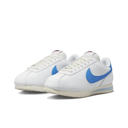 Nike Cortez sneakers front angle pair, white leather with blue swoosh and laces