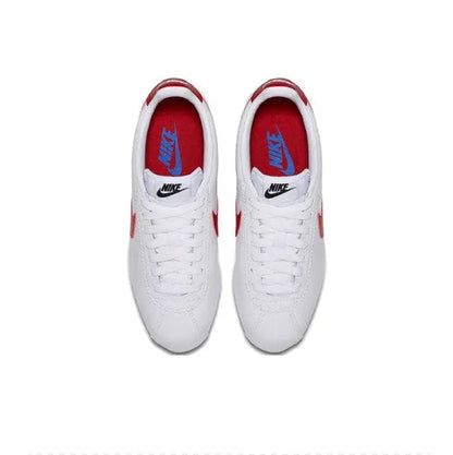 White Nike Cortez sneakers with red-lined tongue and blue Nike heel logo