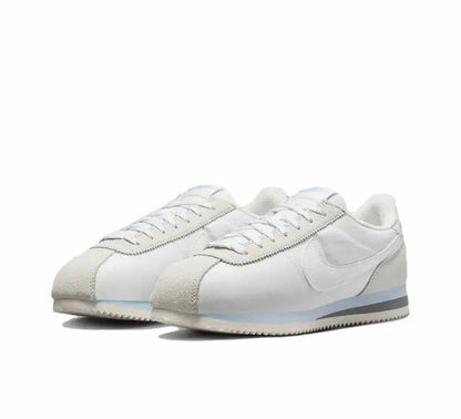 White low-top sneakers with side swoosh and textured toe panel