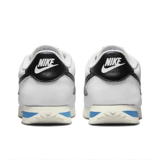 Nike Cortez sneakers, white uppers with black heel Nike badge and blue midsole stripe