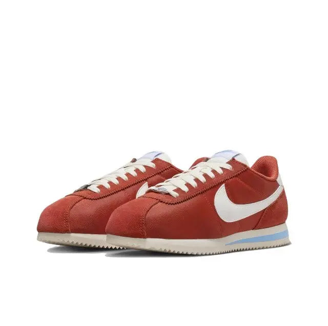 Cortez sneakers side view: red suede, white Swoosh, blue-striped midsole