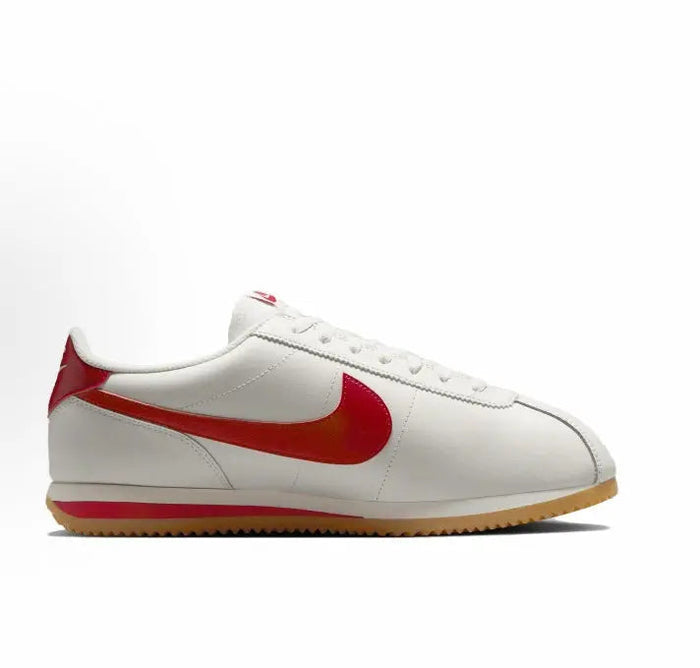 Cortez sneakers side view, white upper with large red swoosh and gum sole