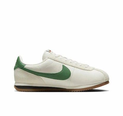 Low-top sneakers profile, white leather with green swoosh and gum sole
