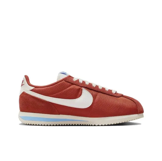Red Cortez sneakers side profile with white Swoosh and blue stripe sole