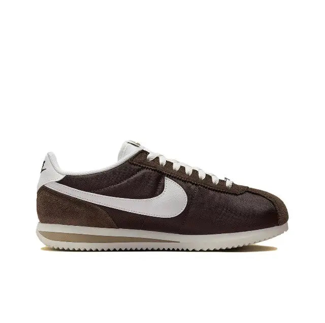 Nike Cortez low-top sneakers in dark brown with white Swoosh, lace-up and padded collar.