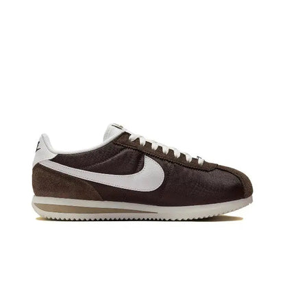 Nike Cortez low-top sneakers in dark brown with white Swoosh, lace-up and padded collar.