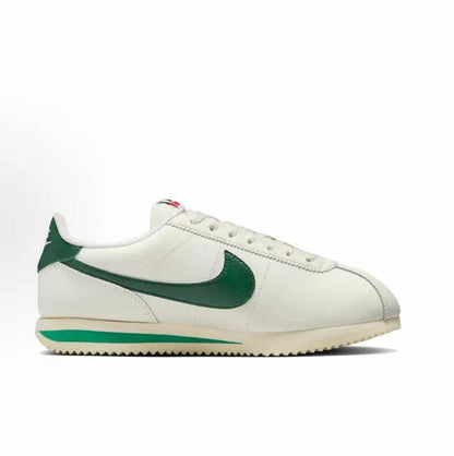 White Cortez sneakers with green swoosh and lace-up front profile