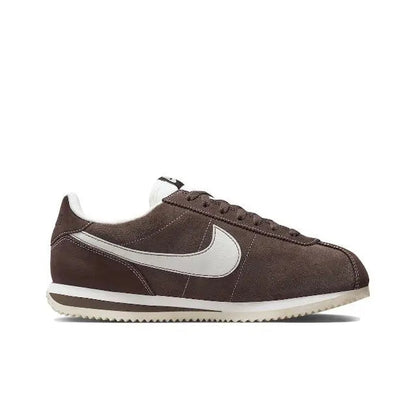 Brown low-top sneakers with white Swoosh and striped rubber sole