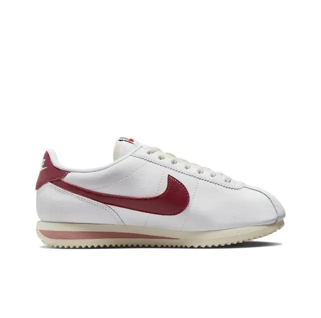 Nike Cortez sneakers, side view in white with burgundy swoosh and lace-up
