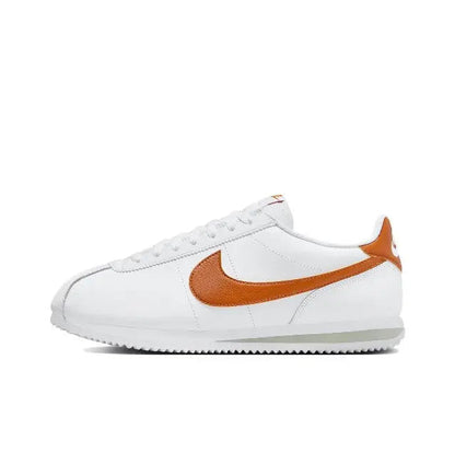 Cortez sneakers, angled side: white upper with orange Swoosh and low-profile sole