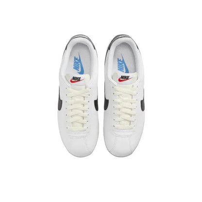 Nike Cortez sneakers, white laced pair with blue Nike logo on tongue