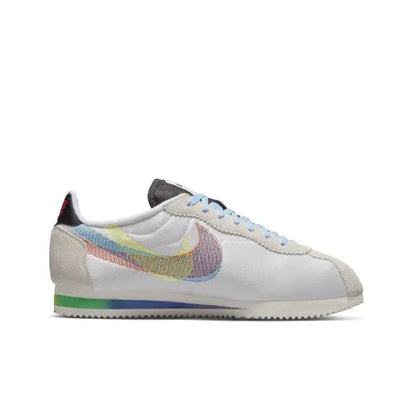 Nike Cortez sneakers, white low-top with rainbow Swoosh and multicolor lining at heel