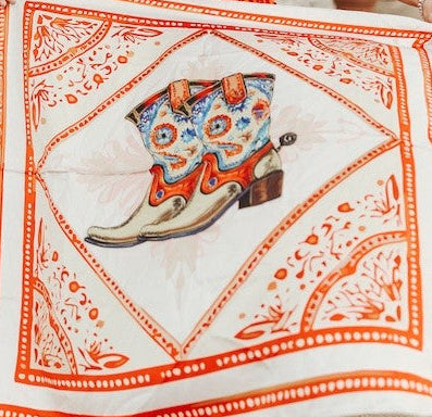 Wild rag scarf in white with orange border, cowboy boot print and paisley accents