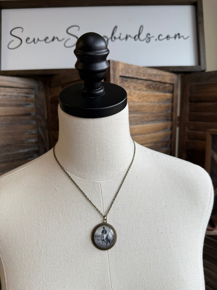 Cowboy glass pendant necklace with round pendant and chain, featuring cowboy and horse