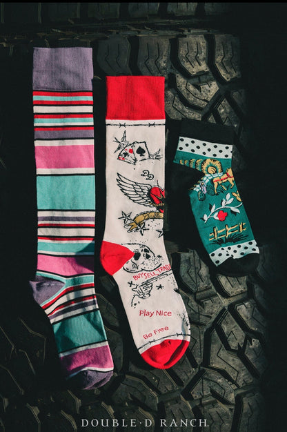3-pack cowboy graffiti socks laid out with purple, white, and teal designs