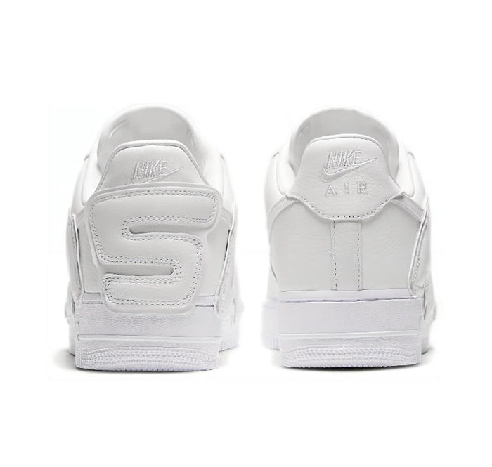 White low-top sneaker heel view with Nike branding on the back tabs.