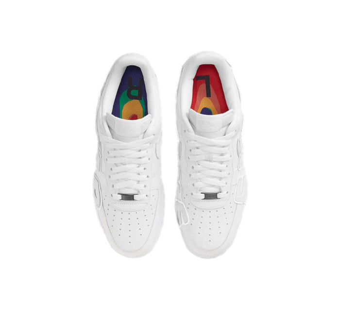 White low-top sneakers showing colorful insole graphics inside the tongue openings.