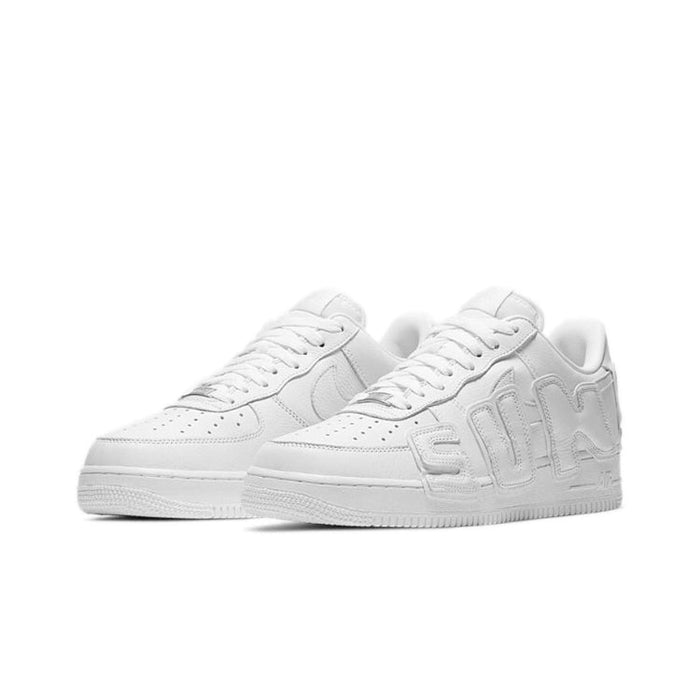 White low-top sneaker front view with tonal laces and sculpted logo overlays.