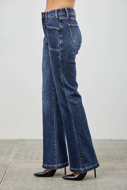 Dark wash bootcut jeans shown from the side with back pockets