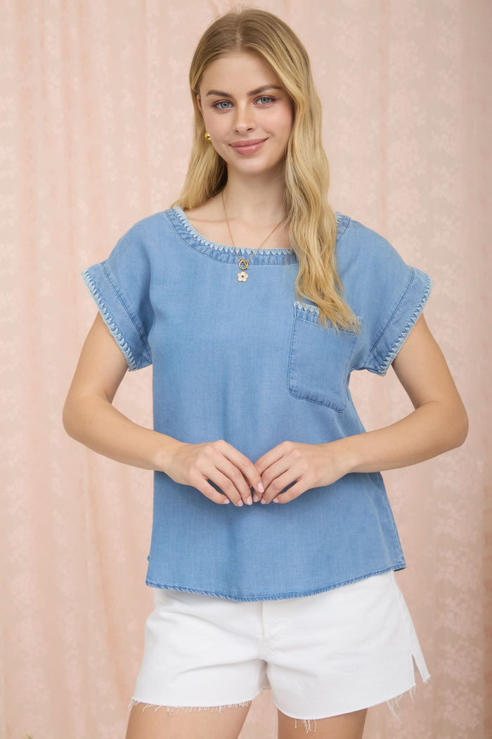 Light blue denim short-sleeve top with chest pocket and whip-stitched trim
