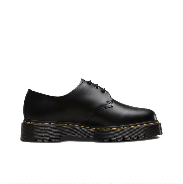 Black smooth leather lace-up shoe with yellow welt stitching and platform sole