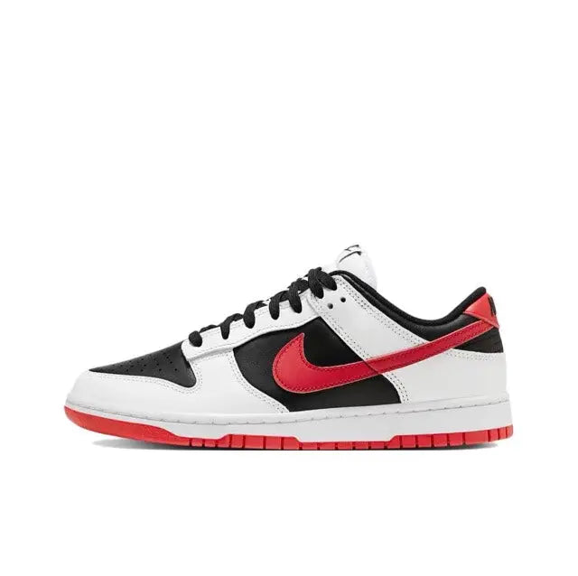 Low-top sneaker with white leather, black overlays, red swoosh, and red outsole