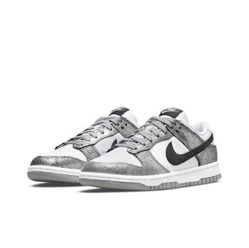 Low-top sneaker in white and silver with black Nike Swoosh, lace-up