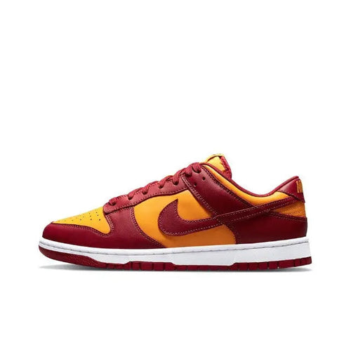 Low-top sneakers in burgundy, gold, and yellow with Nike swoosh, white midsole