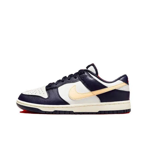 Nike low-top sneakers in navy blue, white, and beige with lace-up closure