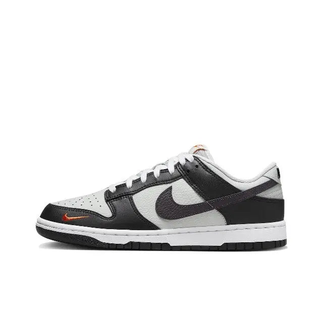 Nike Dunk Low low-top sneaker, black and white with orange swoosh