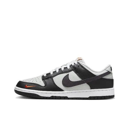 Nike Dunk Low low-top sneaker, black and white with orange swoosh