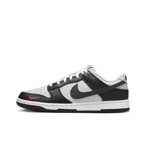 Nike Dunk Low low-top sneaker, black and white with orange swoosh