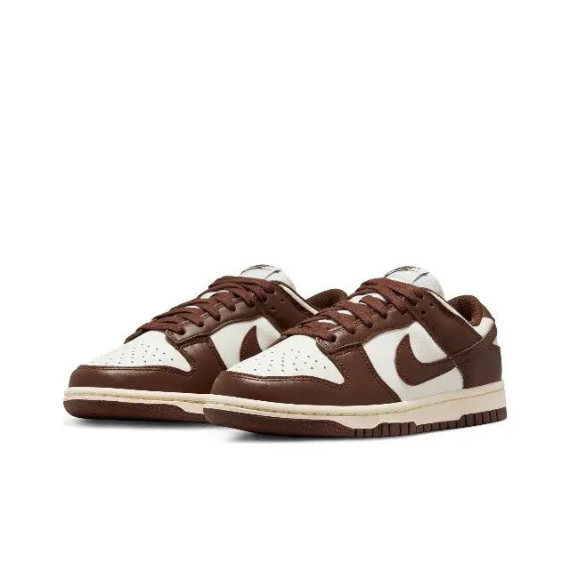 Nike Dunk Low sneakers, brown and white leather with cream sole, lace-up view