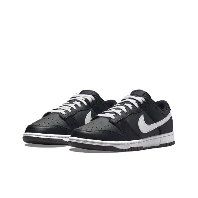 Low-top sneaker pair in black with white Swoosh and striped laces