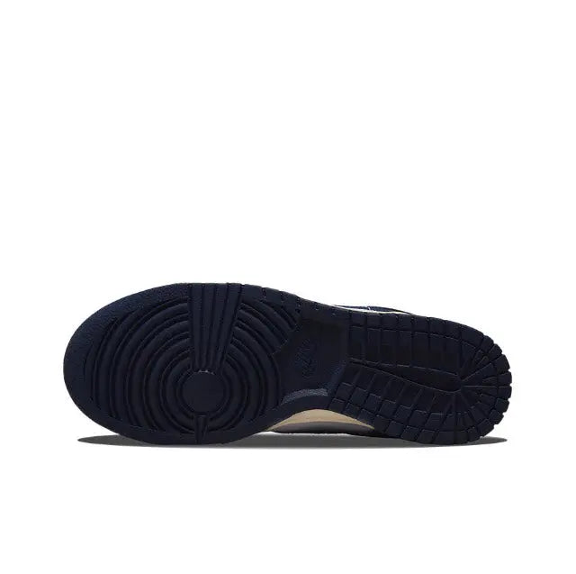 Low-top sneakers outsole view with dark navy tread and cream midsole