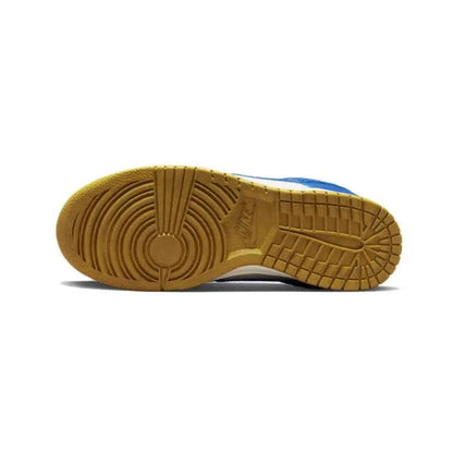 Low-top sneakers outsole view with gum tread and blue heel edge