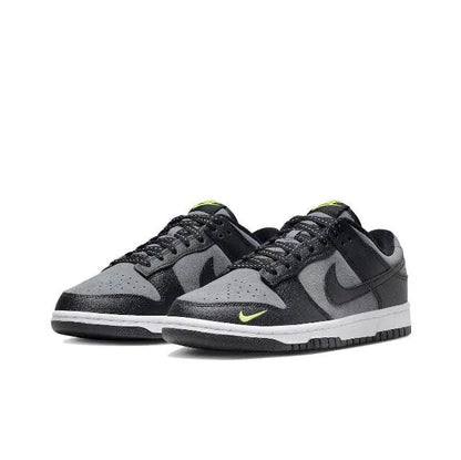 Low-top sneakers, black and gray with green accents on the Swoosh and tongue