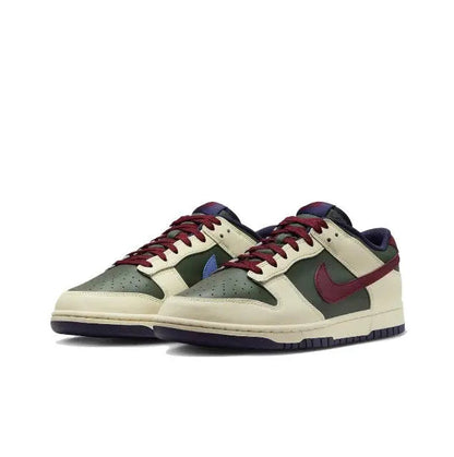 Low-top sneakers, cream base with red laces, green panels, burgundy and navy accents.