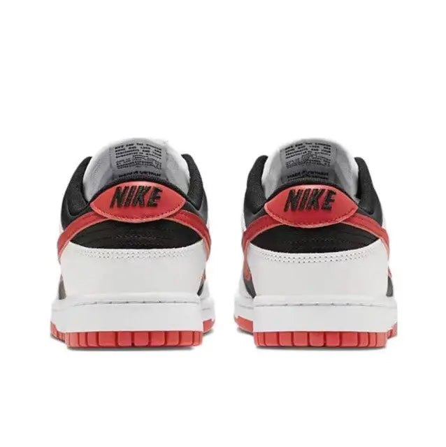 Low-top sneaker heel view with white upper, black collar, and red trim