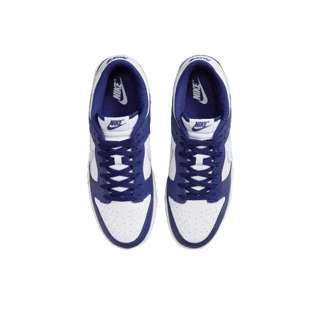 Low-top sneakers with white uppers, deep blue laces, and Nike tongue logo