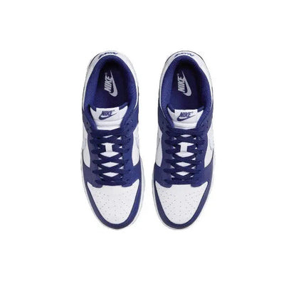 Low-top sneakers with white uppers, deep blue laces, and Nike tongue logo
