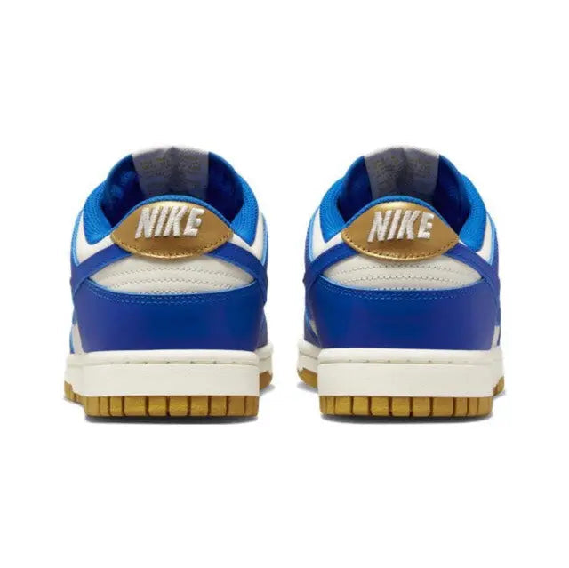 Low-top sneakers back view with Nike logo on blue heel, sail base, gum sole