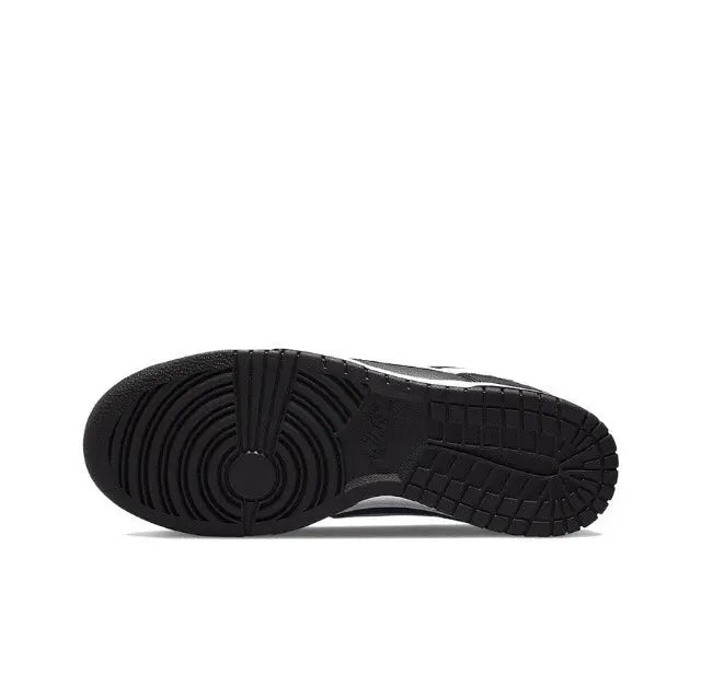 Low-top sneaker outsole view with black rubber tread and circular heel detail