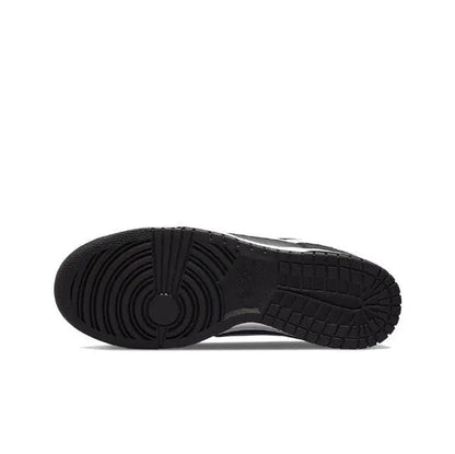 Low-top sneaker outsole view with black rubber tread and circular heel detail